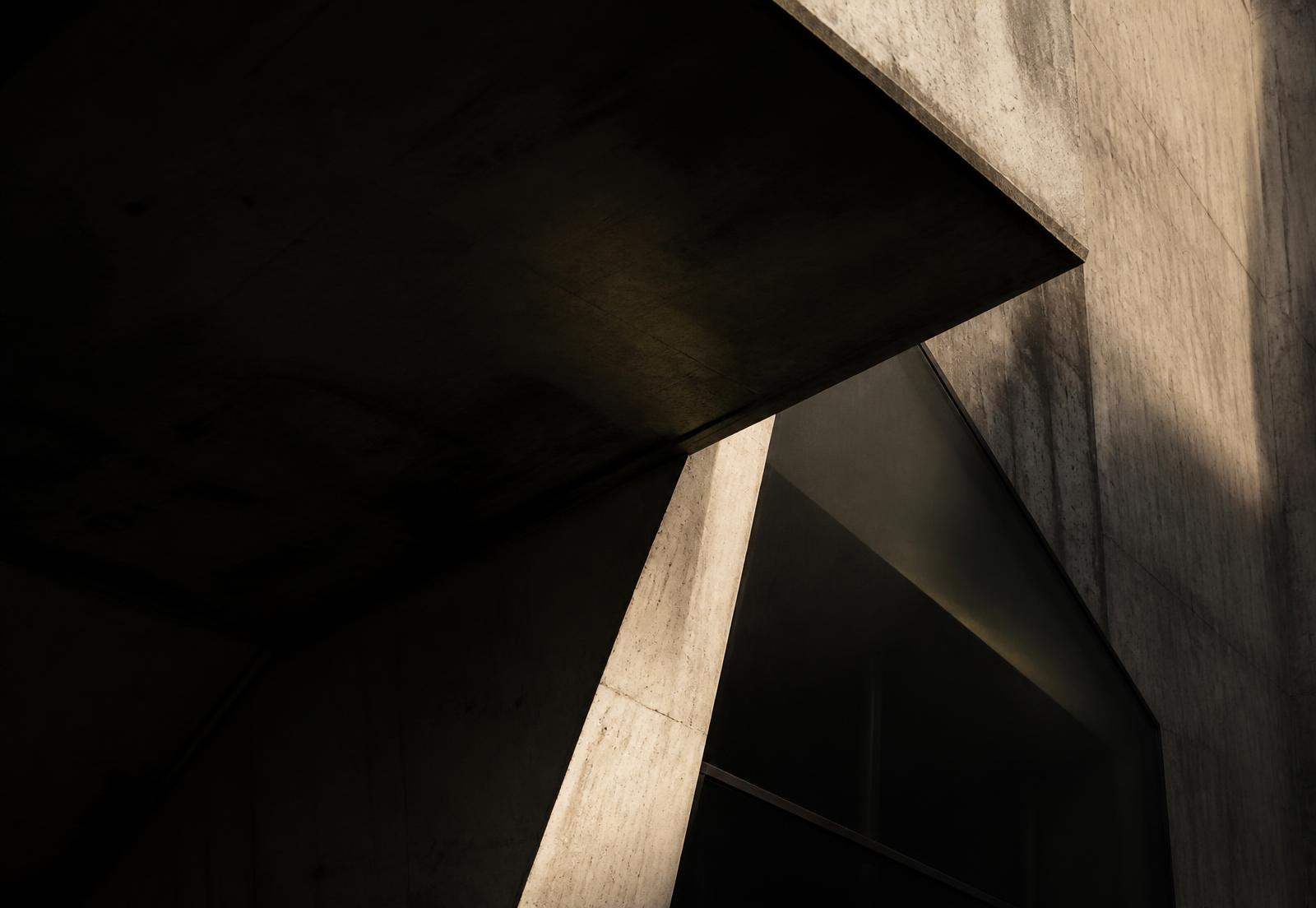 Abstract concrete and glass architectural detail in raking light
